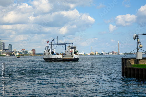 Photography Passenger ferry arriving at a dock on the Toronto Islands with the city skyline