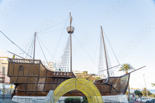 View of the Barco de la Virgen ship replica with tall masts and rigging, situated near the waterfront in Santa Cruz de La Palma, Canary Islands, Spain.