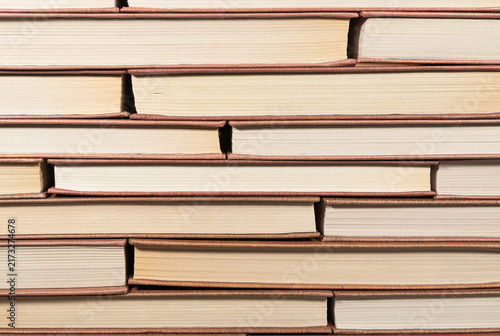 Many books stacked in rows background