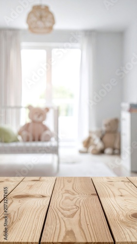 Empty wooden table with minimal blurred baby nursery background