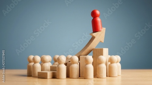 Successful career advancement concept featuring a red wooden figure on an upward arrow and a crowd.