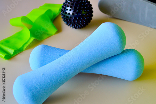 Bild auf Leinwand Colorful physical therapy and rehabilitation equipment including blue foam dumbb