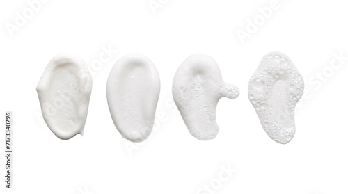 Four white cream foam swatches on transparent backdrop.