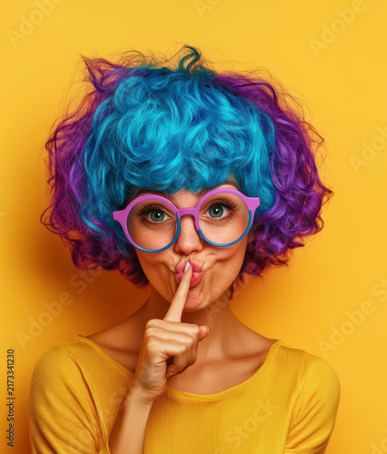 Colorful hair and playful expression with a vibrant background
