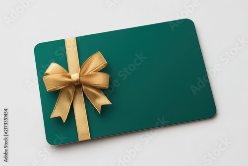 Gift card mock-up template. Green business card with gold ribbon bow accent. Prestigious blank voucher. Emerald coupon on white backdrop. Premium mockup, corporate reward, wedding favor layout. Flyer
