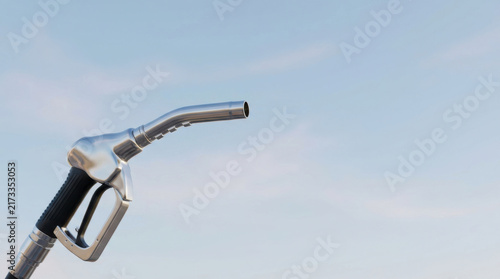 Gasoline nozzle against blue sky with metal fuel pump handle and black grip for refueling vehicles