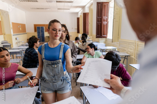Student submitting test turning in exam paper