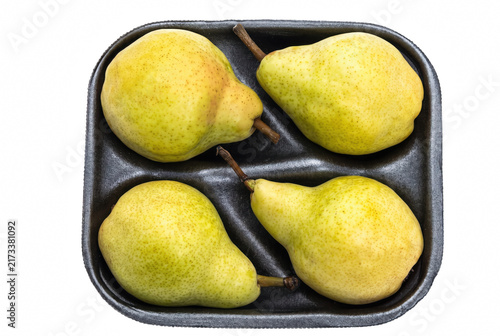 Fotografie Four Ripe Yellow Pears in a Dark Foam Tray