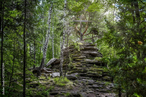 Canvas Print Orthodox cross on a mountain of stones in a dense forest on Vera Island, Chelyab
