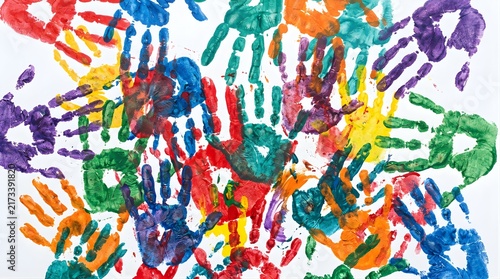 Colorful handprints made with paint on a white background as a concept