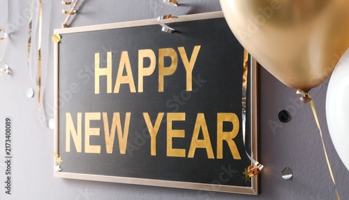 Happy new year framed sign with gold balloons and streamers