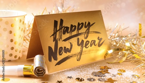 Happy new year card with gold party decorations and confetti