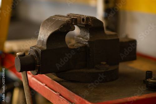 Canvas Print Metal bench vise clamped tightly on workbench in workshop.