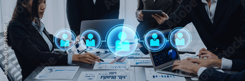 Cuadro en lienzo A business team engages in collaborative work, leveraging digital icons that symbolize networking and enhanced communication in a modern office environment