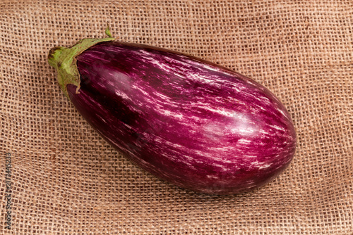 Cuadro en lienzo Raw Graffiti eggplant on a coarse burlap close-up