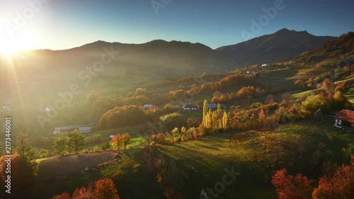 Sunlit Autumn Valley with Mountain Village in Autumn