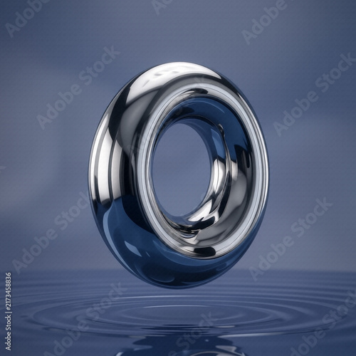 Abstract chrome ring floating above water ripples
