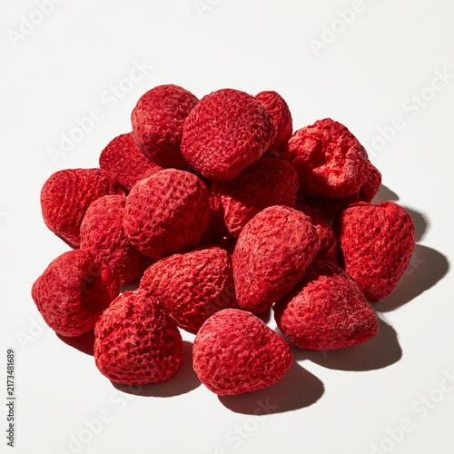 Freeze-dried strawberries rest on white surfaces.