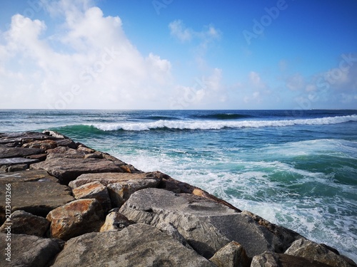 Fotografie Powerful Atlantic Ocean waves break against a rocky shoreline on the coast of Po