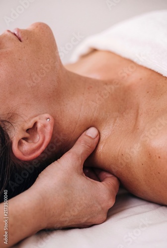 Professional neck massage for woman during relaxing wellness and body care treatment