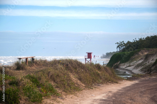 Red lifeguard tower on the beach of the Atlantic ocean in Brazil