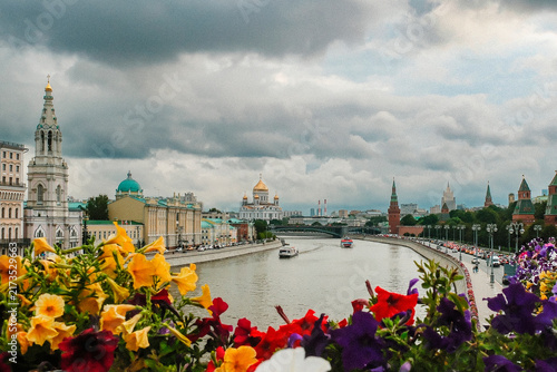 Photography Riverside Moscow skyline with cathedral domes, sightseeing boats, colorful petun
