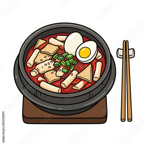 A delicious Korean tteokbokki dish served in a traditional black pot with chopsticks on the side, garnished with green onions and a boiled egg.
