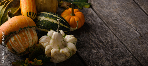 Fotografie Various decorative pumpkins and dry leaves