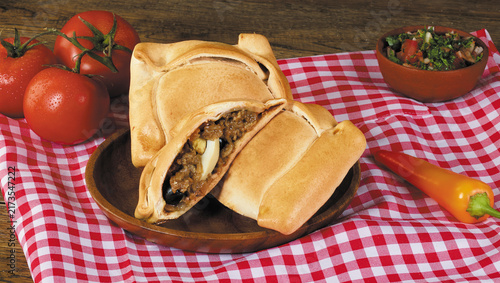 фотографія Baked Chilean beef empanadas filled with minced meat, hard-boiled egg, and olive