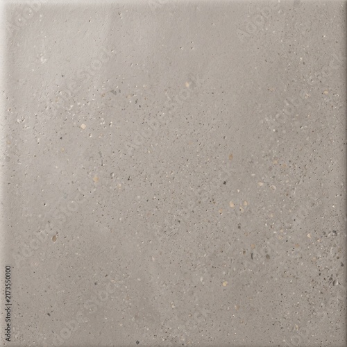 Natural gray concrete wall surface texture with small embedded pebbles and grit particles.