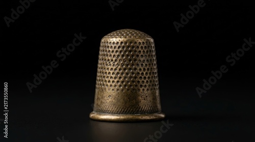 Obraz na płótnie An antique metal thimble used for sewing tasks.