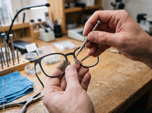 Professional Optician Repairing Eyeglasses with a Small Screwdriver