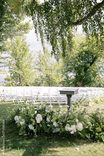 Quadro su tela Outdoor wedding ceremony setup with podium and floral arrangements