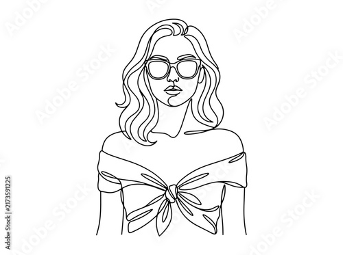 Fashionable woman with wavy hair and sunglasses wearing bow top