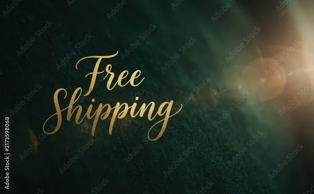 Fototapeta premium Elegant golden free shipping text sign on dark background with lens flare for online store promotion and e-commerce marketing concept