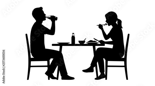 Silhouette couple eating dinner at a table together