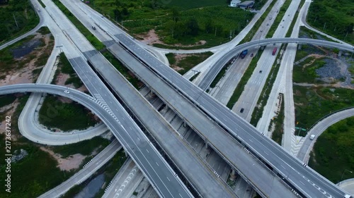 Large road interchange featuring multiple lanes, bridges, ramps, and complex engineering structures represents efficient transportation, highway connectivity, traffic management, logistics, and modern