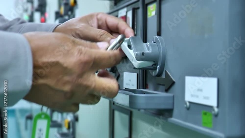 Electrical engineer measuring electrical power at a load panel before applying a lock, demonstrating Lockout Tagout safety procedures, electrical isolation, energy control, and workplace safety in an 