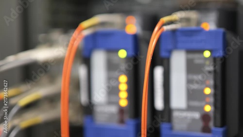 Fiber optic communication converter transmitting digital data signals through optical fiber cable, illustrating high speed telecommunications, network connectivity, data transmission, and advanced com