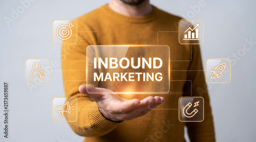 Man holding a glowing virtual sign with the words inbound marketing and icons