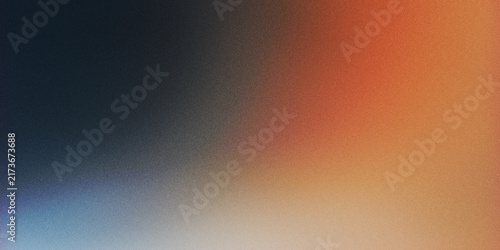 Abstract grainy gradient background with soft transition from dark blue to warm orange and golden light
