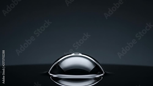 A single reflective liquid metal dome swelling and pulsing on dark surface silver bubble chrome