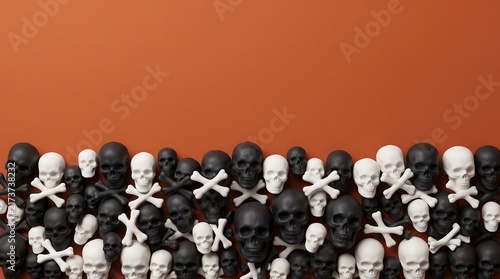A large collection of black and white skull figurines arranged against a solid orange background