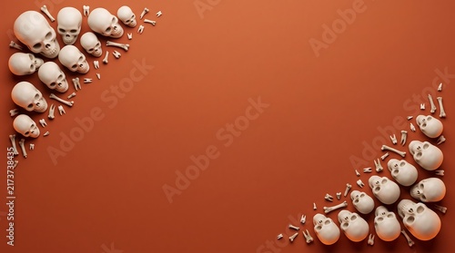 Top view of human skulls arranged in corners on a vibrant orange background for halloween celebration