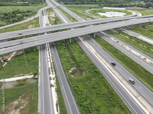 Photography Aerial view of modern highway interchange with overpasses and expressway infrast