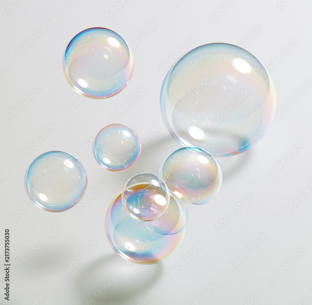 Obraz premium Colorful soap bubbles floating against white background