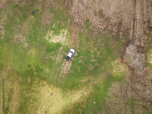 Fotografie Aerial View of Pickup Truck on Muddy Rural Terrain