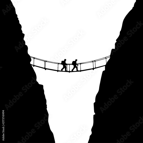 Black and white silhouette illustration of two hikers crossing a suspension bridge over a deep mountain canyon chasm