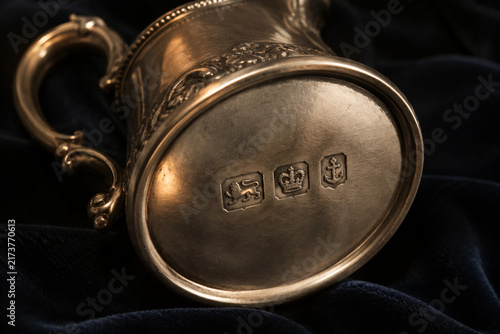 Antique silver cream jug with hallmark stamps on dark velvet, craftsmanship and heritage concept