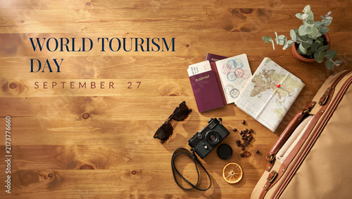 World Tourism Day celebration with travel accessories and wooden background display